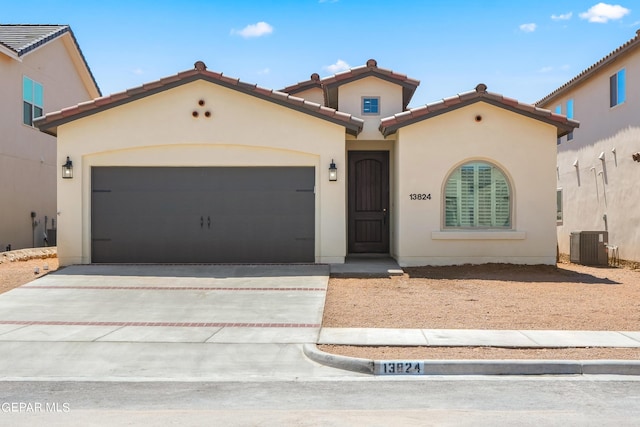 12700 Fredericksberg Ave, El Paso, TX 79928 - mediterranean / spanish house with a tile roof, a garage, stucco siding, concrete driveway, and cooling unit