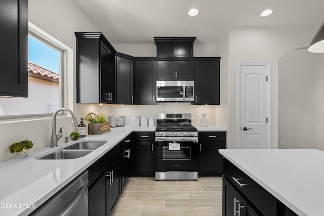 kitchen featuring appliances with stainless steel finishes, light hardwood / wood-style floors, and sink