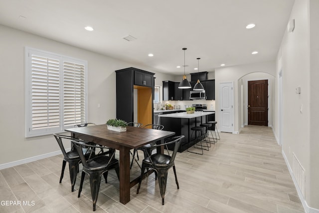 dining room featuring sink and light hardwood / wood-style flooring