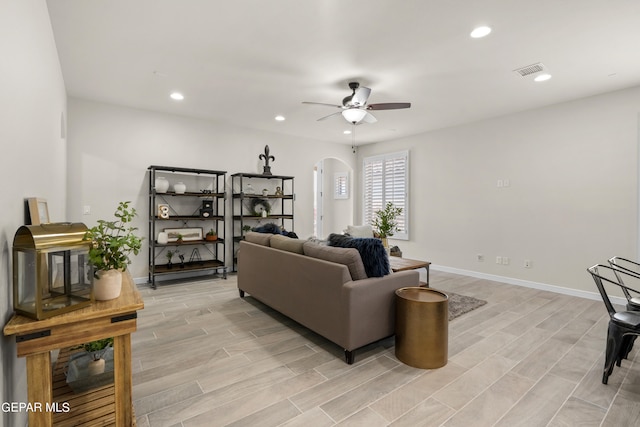 living room with light wood-type flooring and ceiling fan