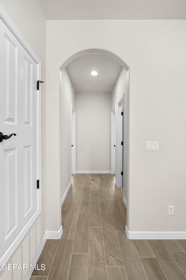 hallway with light hardwood / wood-style floors