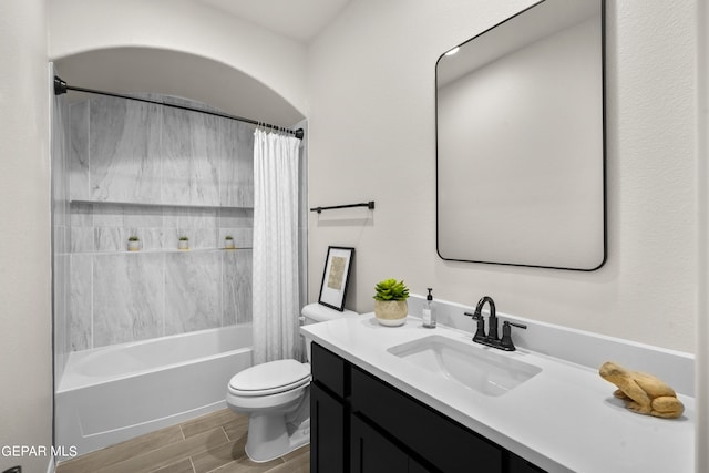 full bathroom featuring vanity, toilet, shower / bathtub combination with curtain, and hardwood / wood-style flooring