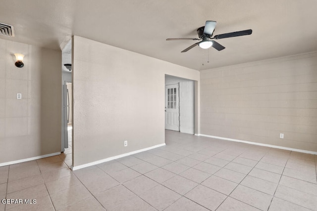 tiled empty room featuring ceiling fan