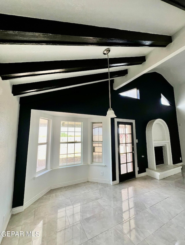 unfurnished room featuring vaulted ceiling with beams