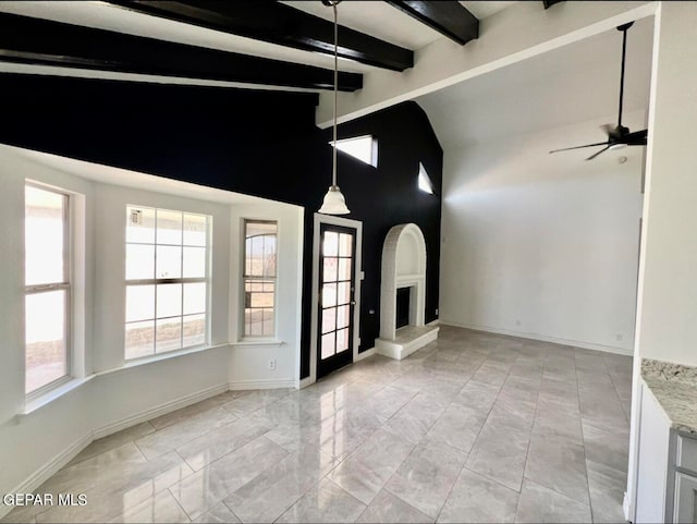 spare room featuring lofted ceiling with beams and ceiling fan