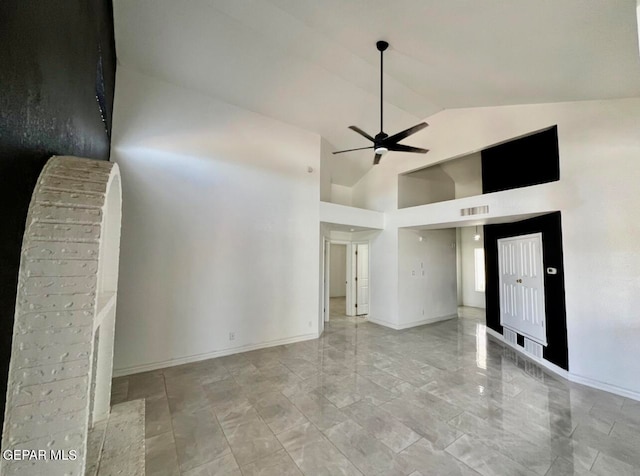 empty room featuring high vaulted ceiling and ceiling fan