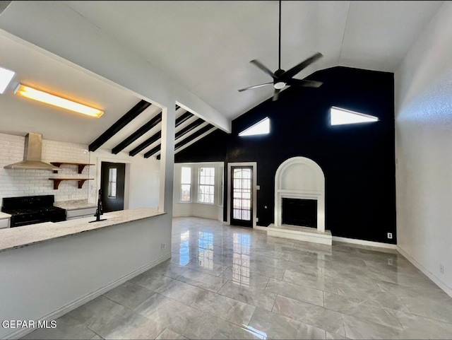 unfurnished living room featuring lofted ceiling with beams and ceiling fan