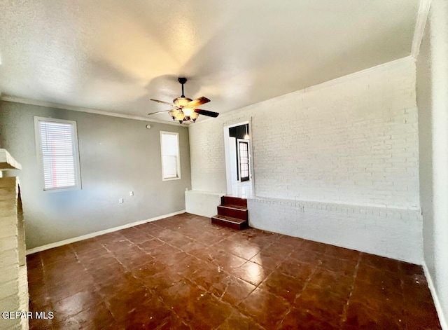 empty room featuring ornamental molding and ceiling fan