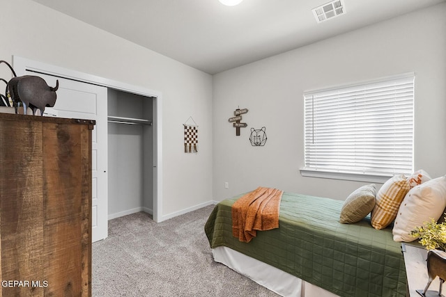 bedroom with light carpet, baseboards, visible vents, and a closet