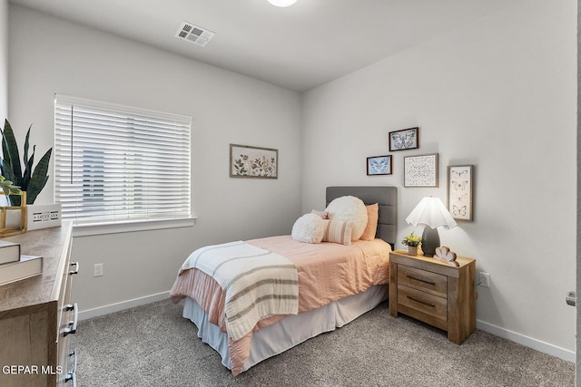 bedroom with baseboards, visible vents, and light colored carpet