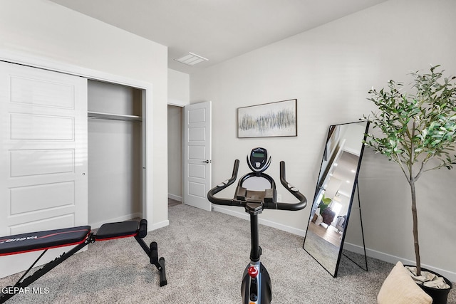 exercise area featuring light colored carpet, visible vents, and baseboards