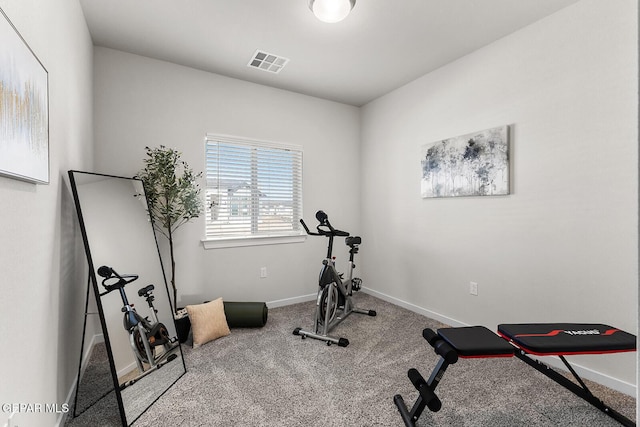 exercise room featuring baseboards, visible vents, and carpet flooring