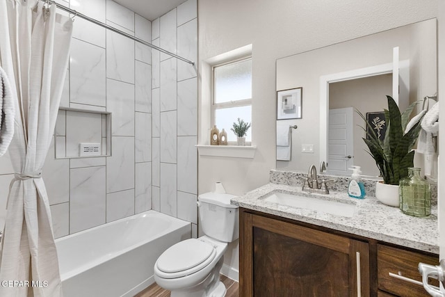 bathroom featuring shower / bath combo, vanity, toilet, and wood finished floors