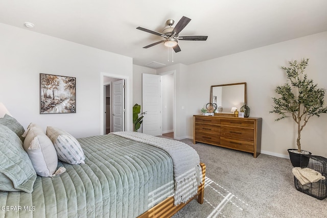 carpeted bedroom with ceiling fan and baseboards