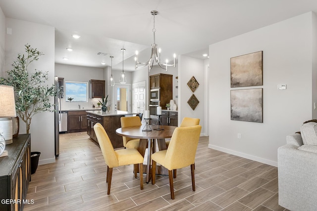 dining room with wood tiled floor, visible vents, baseboards, and recessed lighting