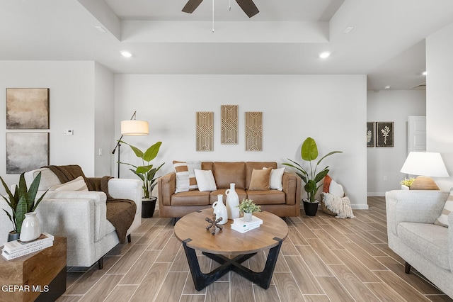 living area featuring wood tiled floor, ceiling fan, baseboards, and recessed lighting