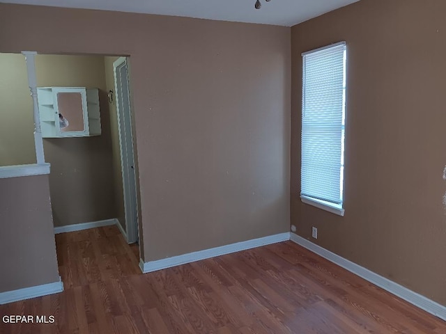 unfurnished room featuring hardwood / wood-style flooring