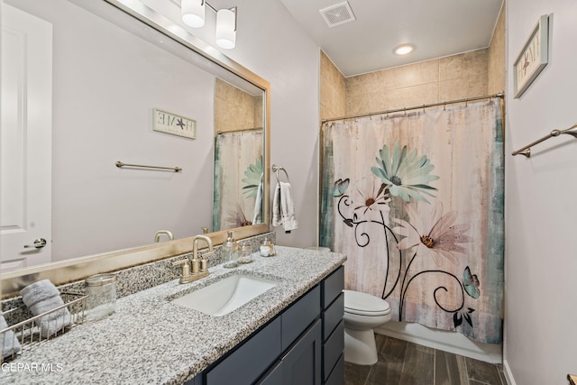 bathroom featuring wood-type flooring, vanity, and toilet