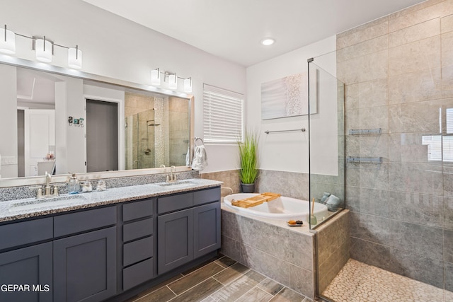 bathroom featuring vanity and plus walk in shower