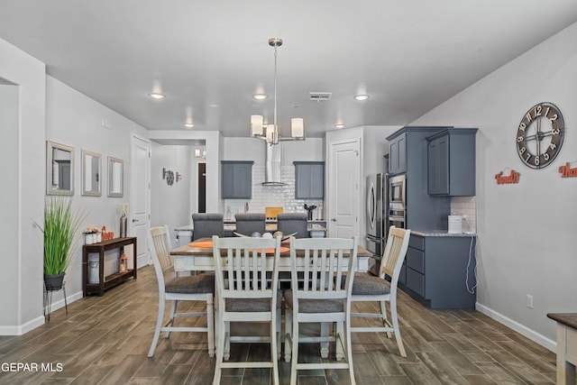 dining room with a notable chandelier and dark hardwood / wood-style floors