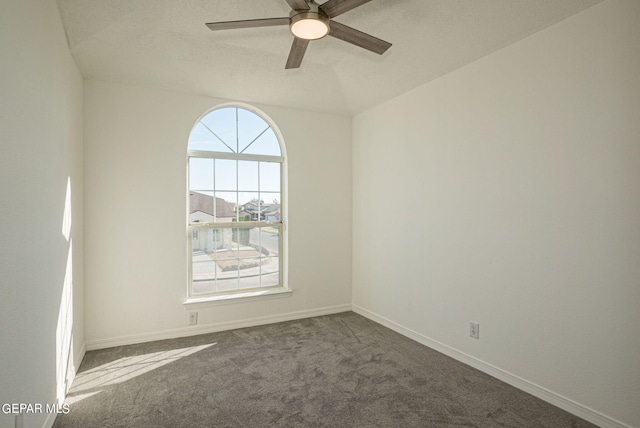 spare room with carpet floors, vaulted ceiling, and ceiling fan