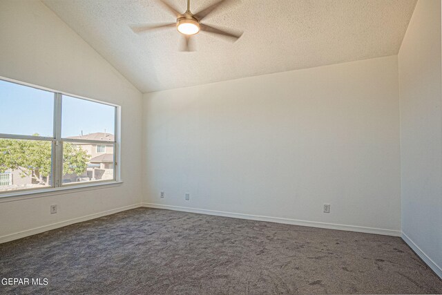 carpeted empty room featuring lofted ceiling, a textured ceiling, and ceiling fan