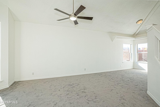 carpeted spare room with lofted ceiling, ceiling fan, and a textured ceiling