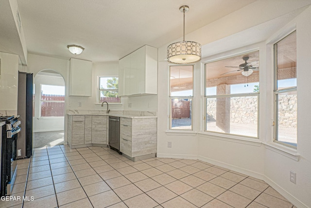 kitchen featuring ceiling fan, white cabinets, hanging light fixtures, sink, and stainless steel appliances