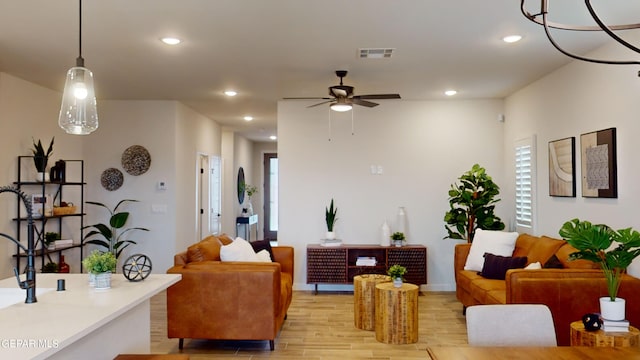 living room featuring light hardwood / wood-style flooring and ceiling fan