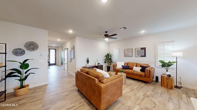 living room with light hardwood / wood-style flooring and ceiling fan