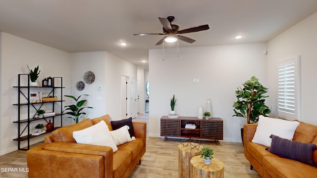 living room featuring ceiling fan and light wood-type flooring