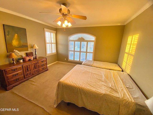 carpeted bedroom with crown molding and ceiling fan