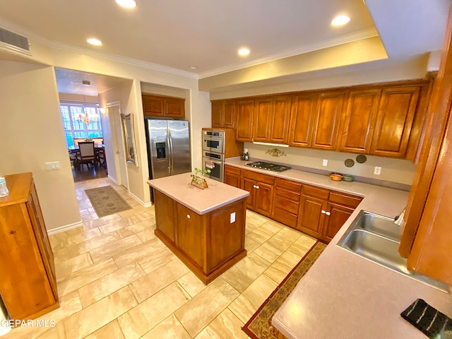 kitchen featuring an inviting chandelier, crown molding, stainless steel appliances, and a kitchen island