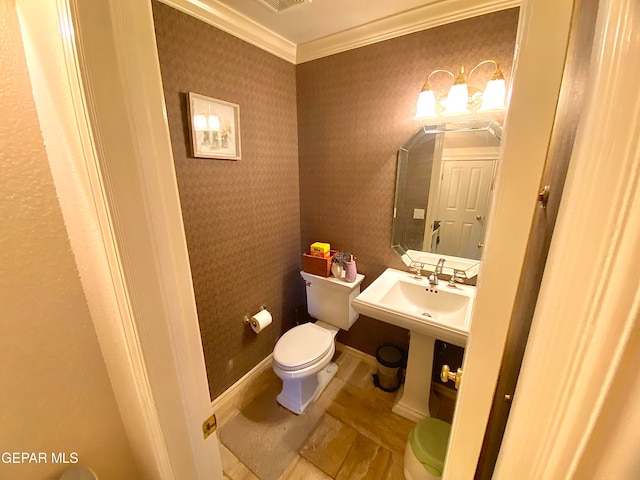 bathroom with crown molding, sink, and toilet