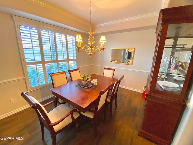 dining space featuring crown molding, dark wood-type flooring, and an inviting chandelier