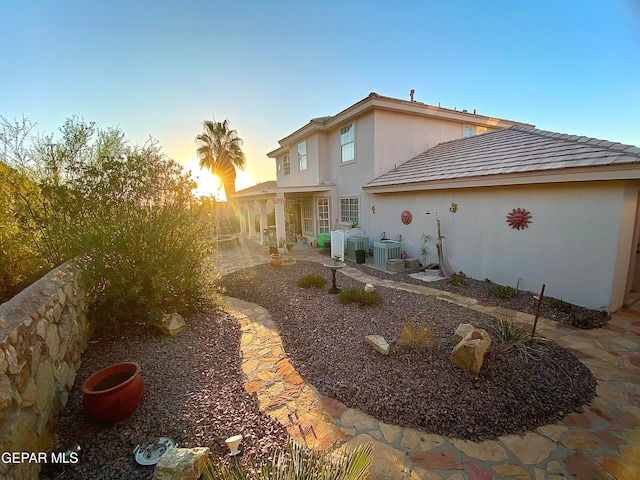 exterior space with central AC unit and a patio area