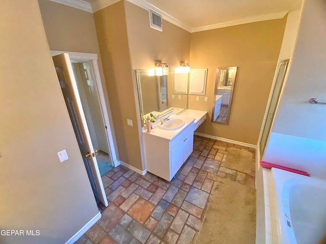 bathroom featuring vanity, crown molding, and a bathing tub