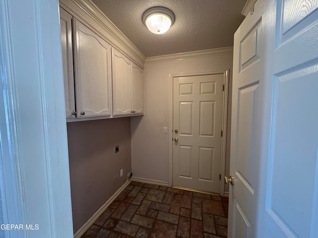 laundry room with cabinets, hookup for an electric dryer, and a textured ceiling