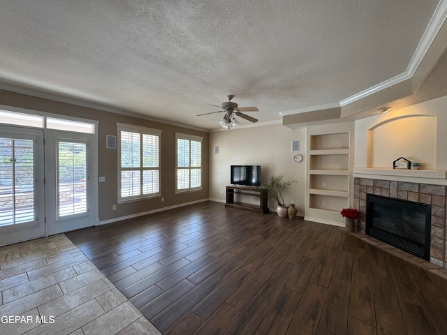 unfurnished living room with crown molding, hardwood / wood-style floors, a textured ceiling, and built in shelves