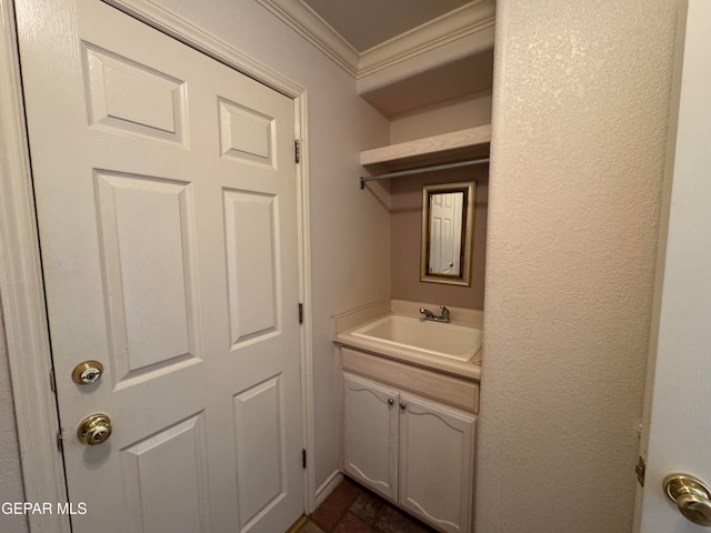 laundry area featuring ornamental molding and sink