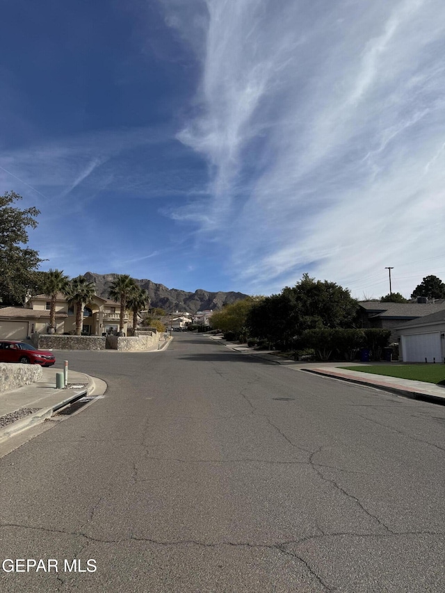 6276 Los Bancos Dr, El Paso, TX 79912 - view of asphalt street with sidewalks and curbs