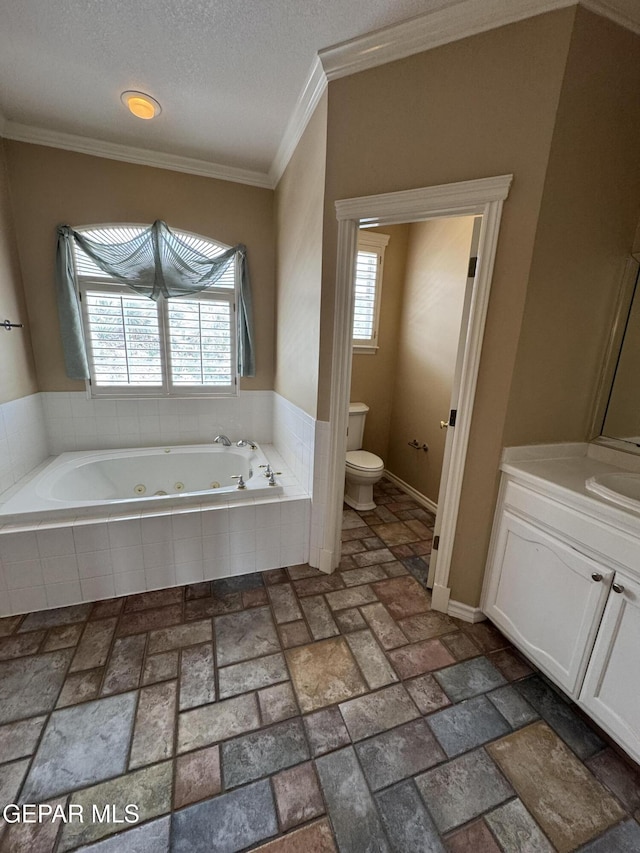 6276 Los Bancos Dr, El Paso, TX 79912 - bathroom featuring a jetted tub, brick patterned floors, vanity, crown molding, and a textured ceiling