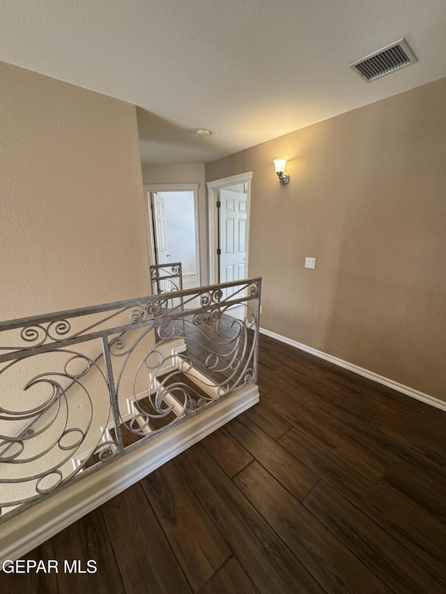 6276 Los Bancos Dr, El Paso, TX 79912 - hallway featuring dark wood-type flooring and baseboards