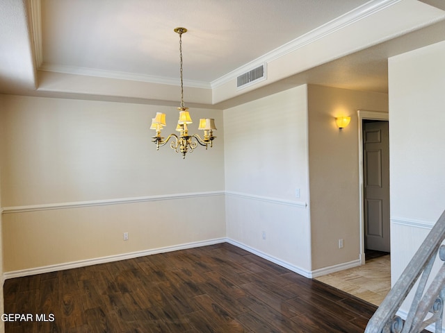 6276 Los Bancos Dr, El Paso, TX 79912 - empty room with ornamental molding, wood finished floors, a chandelier, and a tray ceiling