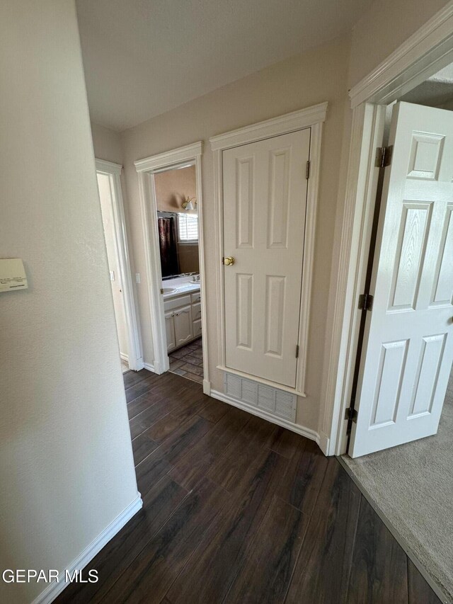 6276 Los Bancos Dr, El Paso, TX 79912 - hallway with baseboards and dark wood-type flooring