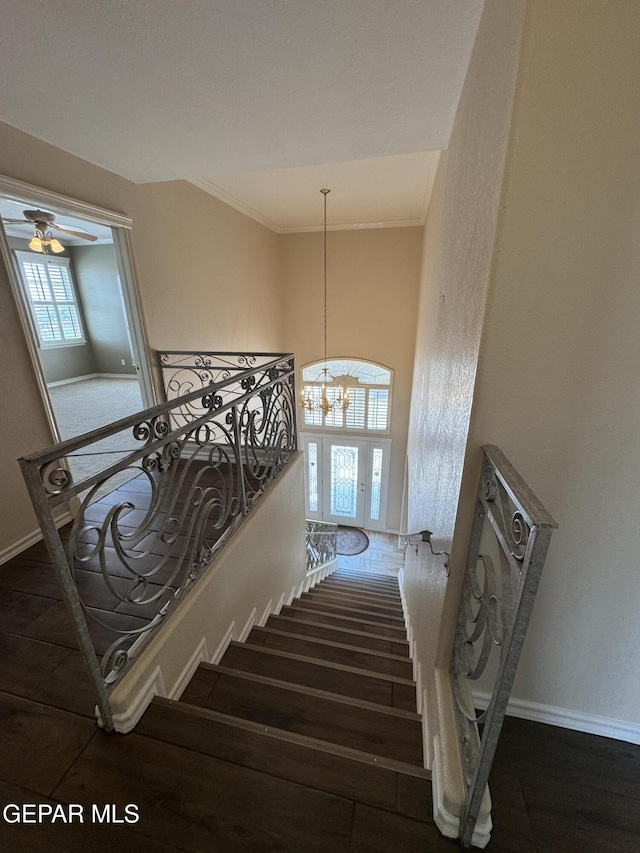 6276 Los Bancos Dr, El Paso, TX 79912 - stairs featuring wood finished floors, a chandelier, crown molding, and ceiling fan