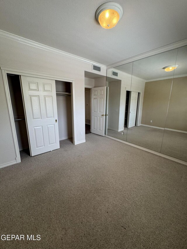 6276 Los Bancos Dr, El Paso, TX 79912 - unfurnished bedroom featuring crown molding, carpet, and multiple closets