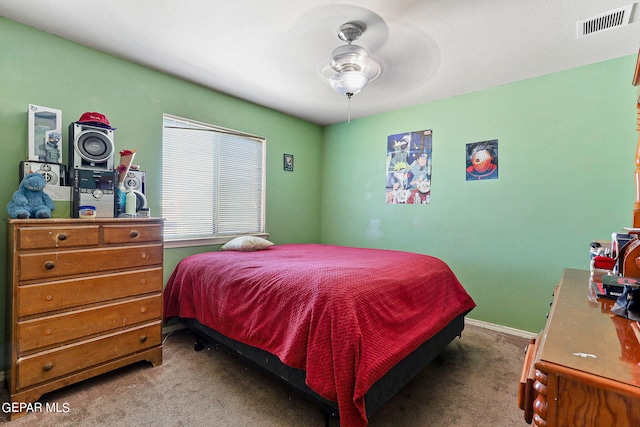 bedroom featuring ceiling fan, visible vents, and carpet