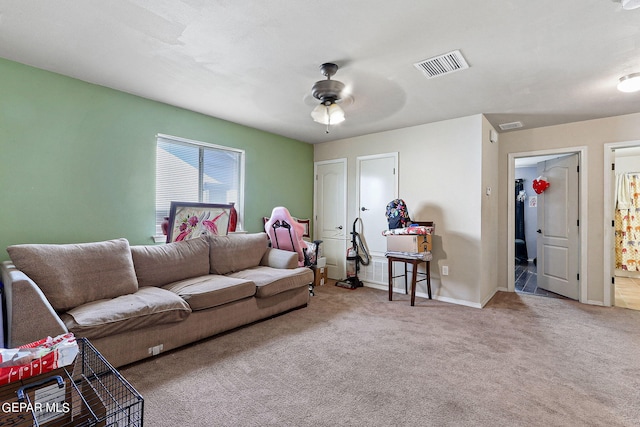 carpeted living room featuring baseboards, ceiling fan, and visible vents