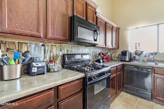 kitchen featuring light countertops, black appliances, and tasteful backsplash